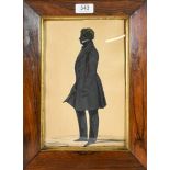 An Early 19th Century Silhouette of a Gentleman, standing wearing a frock coat, with white