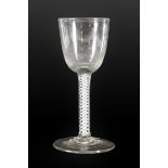 A Wine Glass, circa 1750, the semi-fluted ovoid bowl on an air twist stem, 14cm high; A Similar Wine