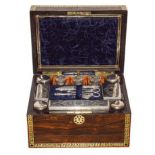 A Victorian Rosewood and Brass Inlaid Travelling Toilet Set, the hinged rectangular top set with a