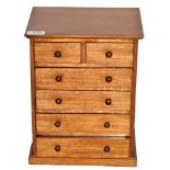 A Victorian Mahogany Miniature Chest, of two short and four long drawers with turned wood handles,