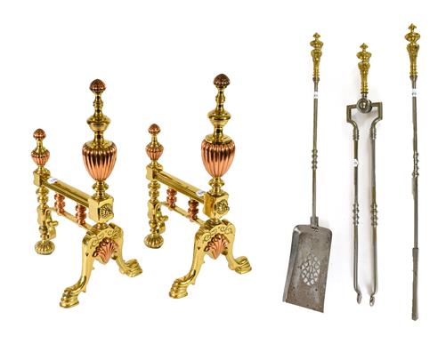 A Pair of Brass and Copper Fire Dogs, with fluted urn finials, on cabriole front supports centred by