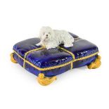 A Staffordshire Majolica Box and Cover, circa 1880, modelled as a dog sitting on a tasselled cushion