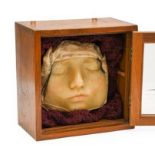 A Wax Death Mask of a Girl, possibly 18th century, contained in a glazed box, 21.5cm wide overall