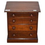 A Victorian Mahogany Miniature Chest, of four long graduated drawers, on plinth base, 30cm wide.