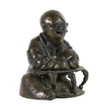 A Japanese Bronze Figure of a Scholar, Meiji period, seated at a low table, 12.5cm high. Small crack