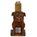 A French Walnut Brush Stand, circa 1900, carved as a fore-quarter of a bulldog with glass eyes, on a