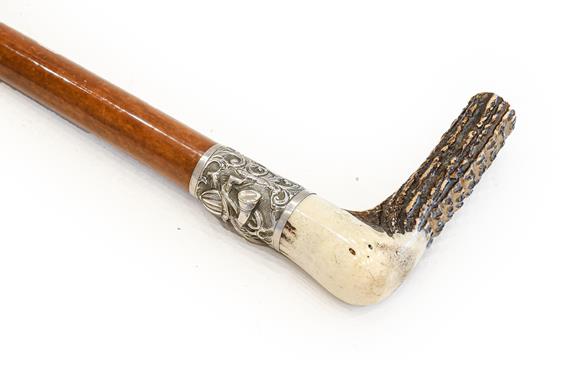 A Late Victorian Malacca Hunting Whip, with antler handle and silver collar richly embossed with a