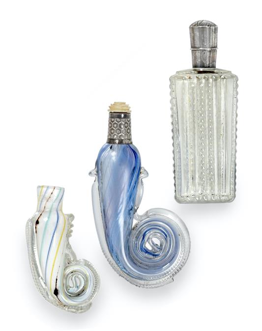 Two Glass Scent-Bottles, each with rolled end, one with silver-mounted neck and carved flower