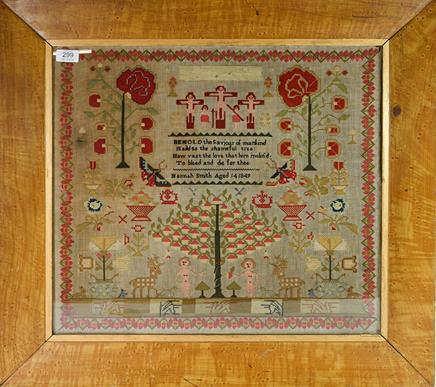 An Early Victorian Needlework Sampler, worked in cross stitch in coloured wools with the Crucifixion