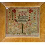 An Early Victorian Needlework Sampler, worked in cross stitch in coloured wools with the Crucifixion