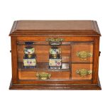 A Victorian Glazed Oak Stationery Cabinet, of rectangular form with brass handles, the hinged top