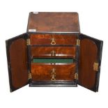 A Victorian Walnut and Ebonised Table Cabinet, of rectangular form, with two panel doors enclosing