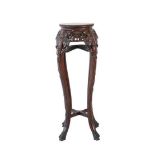 A Chinese Padouk Wood and Pink Marble Plant Stand, circa 1900, the circular top with carved border