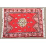 Moroccan Berber Rug, Late 20th Century The crimson field with roundel medallion framed by floral