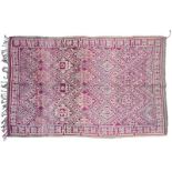 Moroccan Carpet, 2nd quarter 20th century The aubergine diamond lattice field of hooked motifs