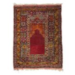 Anatolian Prayer Rug, circa 1900 The crimson field beneath a stepped Mihrab enclosed by borders of