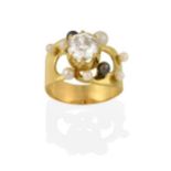 An 18 Carat Gold Diamond and Cultured Pearl Ring, the raised round brilliant cut diamond in a yellow