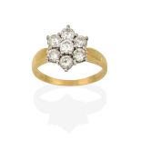 A Diamond Cluster Ring, the round brilliant cut diamond within a border of further round brilliant