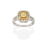 A Diamond Cluster Ring, the cushion cut yellow diamond within a spaced border of round brilliant cut