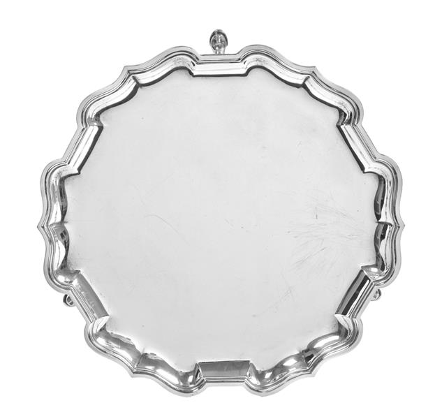 A George V Silver Waiter, by Mappin and Webb, London, 1920, shaped circular and on three pad feet,