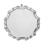 A George V Silver Waiter, by Mappin and Webb, London, 1920, shaped circular and on three pad feet,