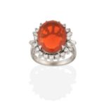 A Fire Opal and Diamond Cluster Ring, the oval cut fire opal within a border of eight-cut diamonds