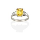 An Art Deco Style Yellow Sapphire and Diamond Ring, the emerald-cut yellow sapphire in a yellow claw