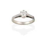 A Diamond Solitaire Ring, the round brilliant cut diamond in a white double claw setting, to a