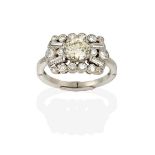 A Diamond Cluster Ring, the central round brilliant cut diamond in a white claw setting, within a