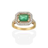 A 9 Carat Gold Emerald and Diamond Cluster Ring, the emerald-cut emerald in a yellow claw setting,