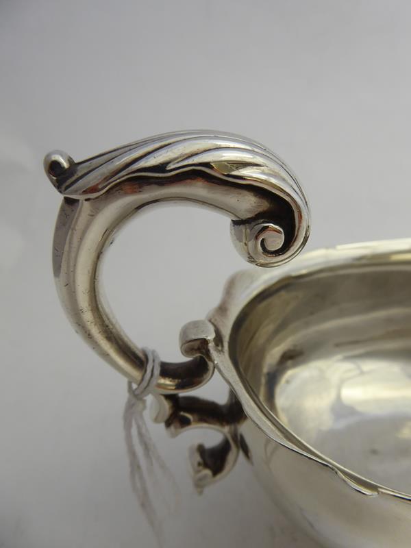 A George II Silver Sauceboat, by John Barbe, London, 1745, oval and on three scroll capped pad feet, - Image 4 of 9