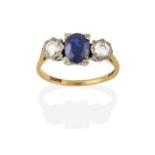 An 18 Carat Gold Sapphire and Diamond Three Stone Ring, the oval cut sapphire in a white claw