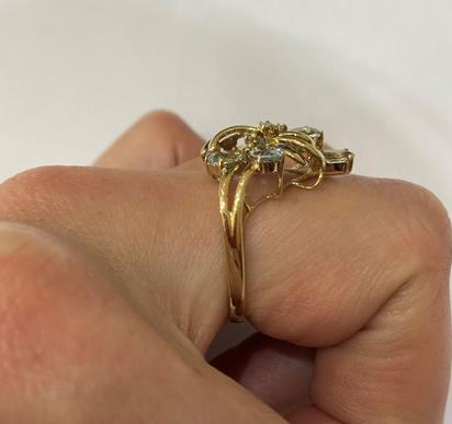 A 9 Carat Gold Aquamarine Ring, the floral motif set throughout with oval cut aquamarines and - Image 6 of 8