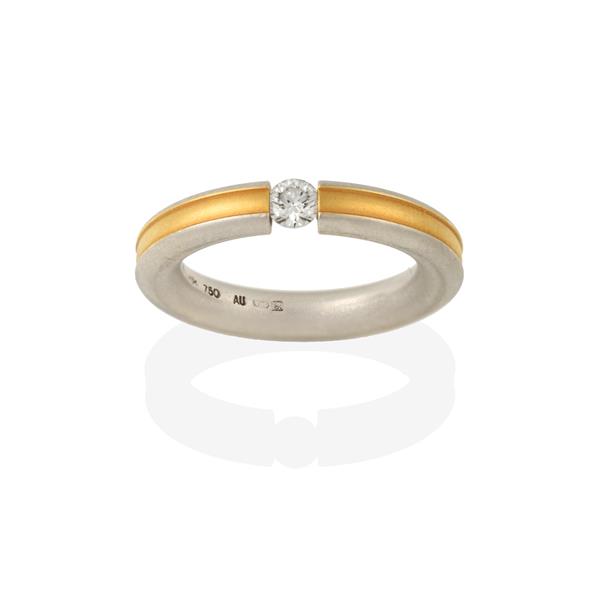 A Diamond Solitaire Ring, the round brilliant cut diamond tension set between a band formed of