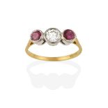 An 18 Carat Gold Ruby and Diamond Three Stone Ring, the round brilliant cut diamond flanked by round