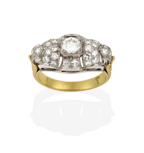 A Diamond Cluster Ring, a round brilliant cut diamond to an openwork border set throughout with