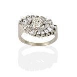 A Diamond Cluster Ring, the central round brilliant cut diamond within a swirl border formed of