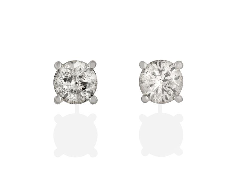 A Pair of Diamond Solitaire Earrings, the round brilliant cut diamonds in white four claw