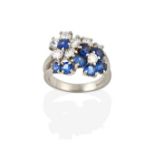 A Sapphire and Diamond Cluster Ring, realistically modelled as two floral motifs, one cluster formed