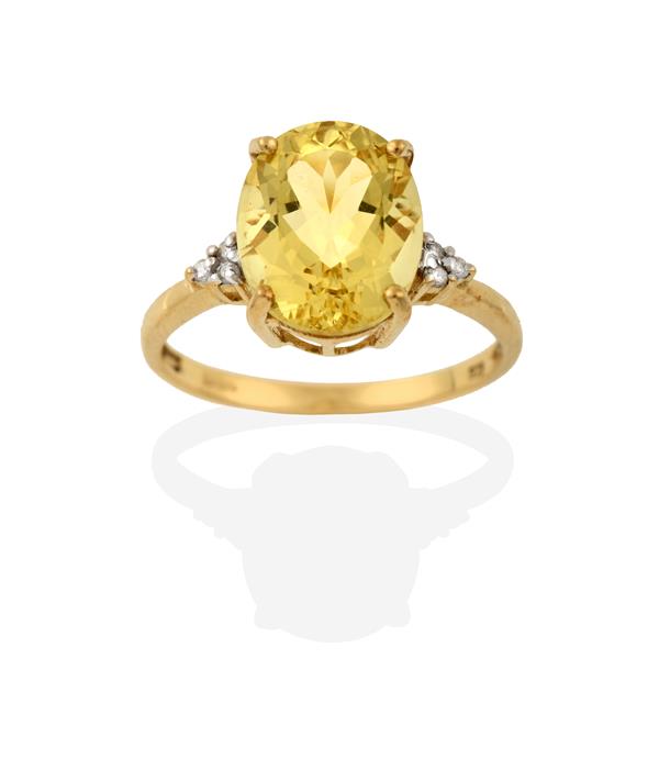 A 9 Carat Gold Heliodor Beryl and Diamond Ring, the oval cut heliodor flanked by trios of round