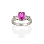 A Pink Sapphire and Diamond Ring, the oval cut pink sapphire in a white claw setting, to a