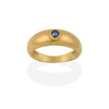 A Sapphire Ring, by Cartier, a round cut sapphire inset within a yellow plain polished band,