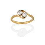 A Diamond Two Stone Twist Ring, the round brilliant cut diamonds in white millegrain settings, to
