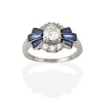 A Synthetic Sapphire and Diamond Cluster Ring, the round brilliant cut diamond flanked by tapered