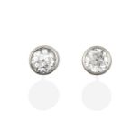 A Pair of 18 Carat White Gold Diamond Solitaire Earrings, the round brilliant cut diamonds in rubbed