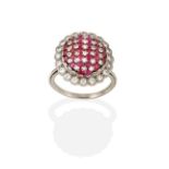 A Ruby and Diamond Ring, the central oval dome formed of rows of round cut rubies alternating with
