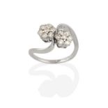 An 18 Carat White Gold Diamond Double Cluster Twist Ring, the clusters formed of round brilliant cut