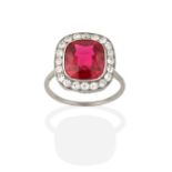 A Synthetic Ruby and Diamond Cluster Ring, the cushion cut synthetic ruby in a white rubbed over