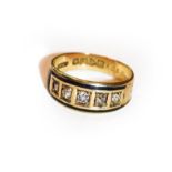 An 18 carat gold enamel and diamond five stone ring, finger size L. Enamel loss throughout. Gross