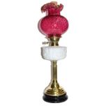 Brass table till lamp with opaline embossed oil well and cranberry shade